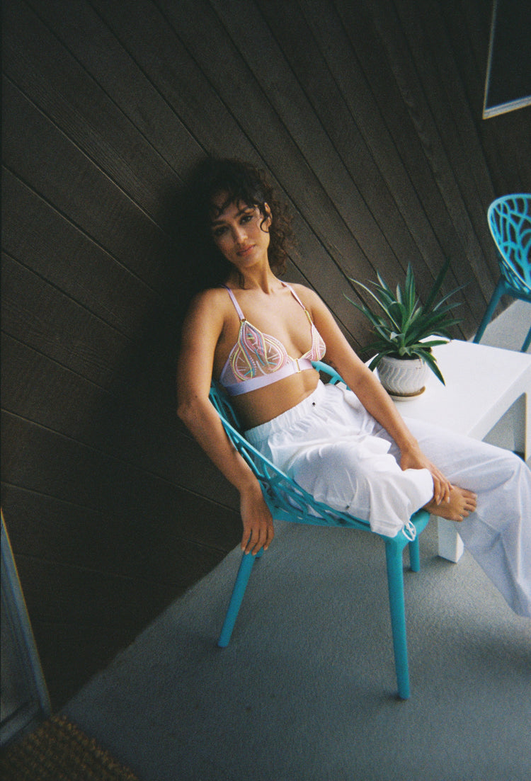 LIFESTYLE SHOT GIRL SAT ON CHAIR PURPLE BRALETTE
